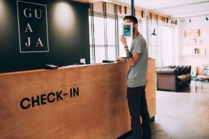 Man covering face at hotel check in