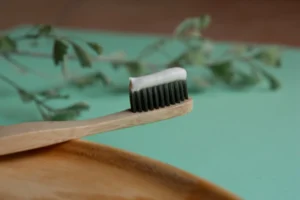 Plastic-free travel Eco-friendly Bamboo Toothbrush on Green Background